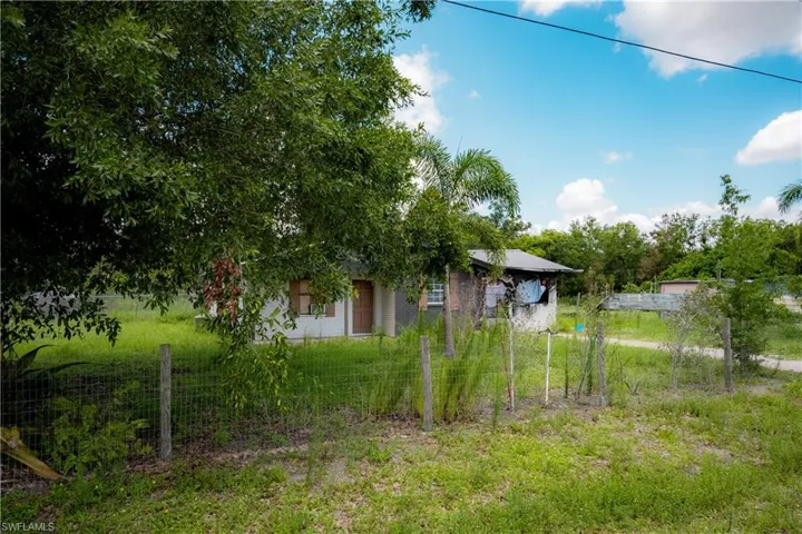 Single-story residence featuring a white facade and a covered porch