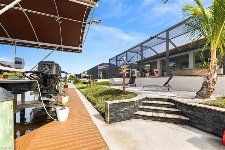 View of composite dock with 3 boat lifts, custom private beach and kayak rack