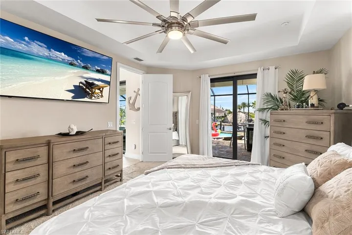 Owners suite featuring access to outside and ceiling fan