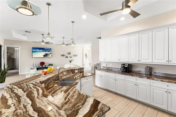 Kitchen with white cabinetry and granite countertops