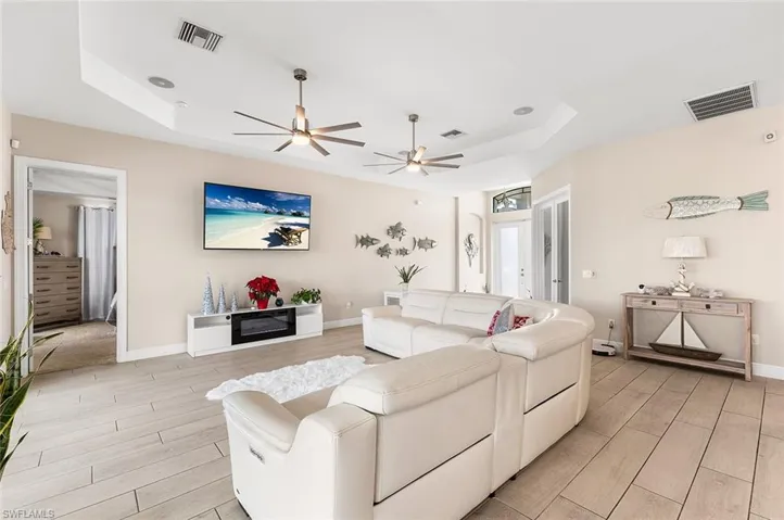 Living room with plentiful natural light and tray ceiling
