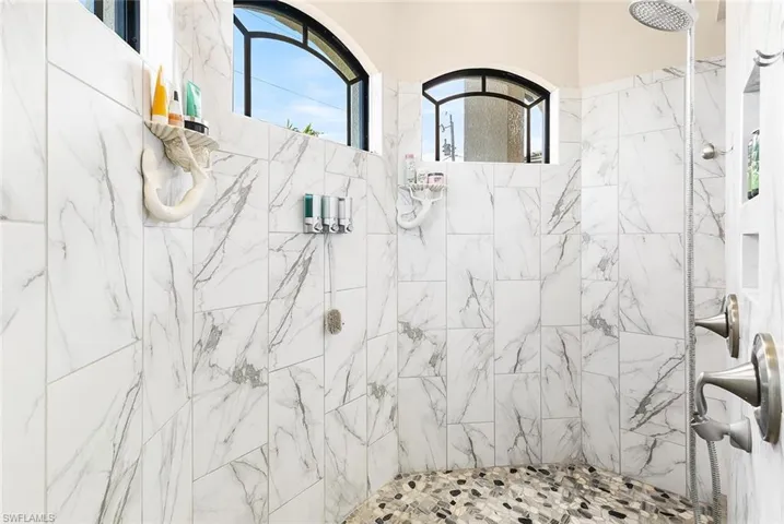 Owners bathroom featuring tiled shower