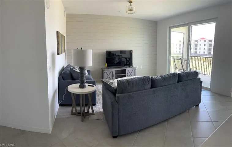 Tiled living area featuring wood walls and an accent wall