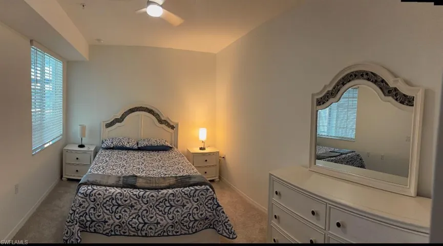 Bedroom featuring light carpet and ceiling fan