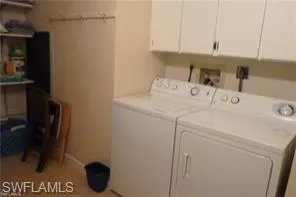 Washroom with washing machine and dryer and cabinet space