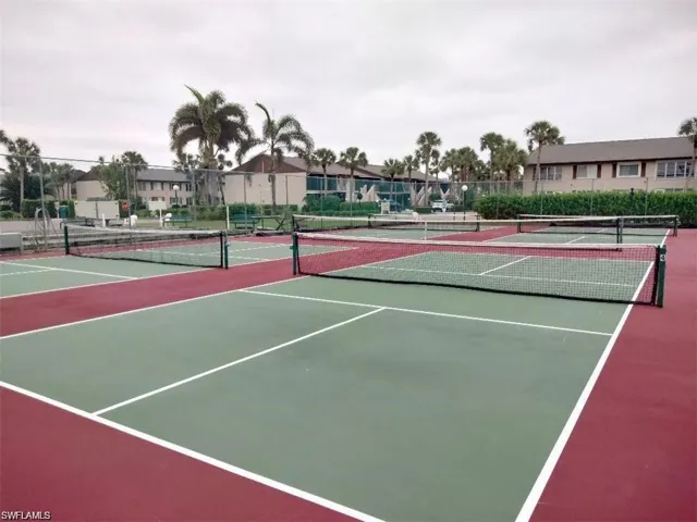 View of tennis court with community basketball court and a residential view