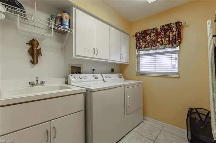 Kitchen featuring light tile patterned floors, decorative light fixtures, a chandelier, and open floor plan