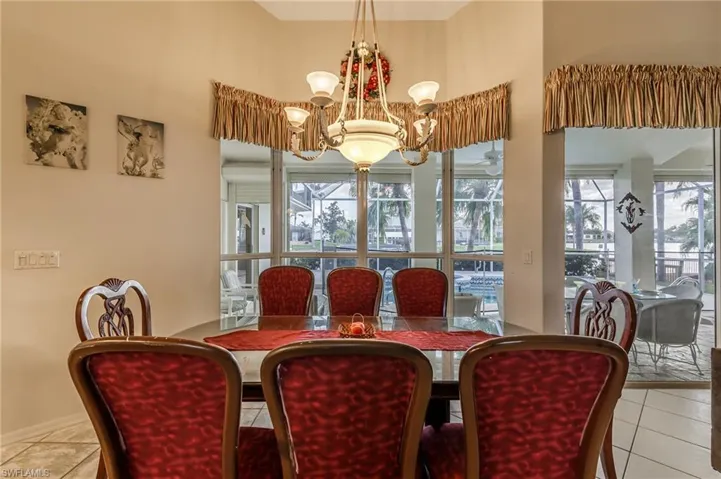 Bedroom with light tile patterned floors, ceiling fan, a raised ceiling, and recessed lighting