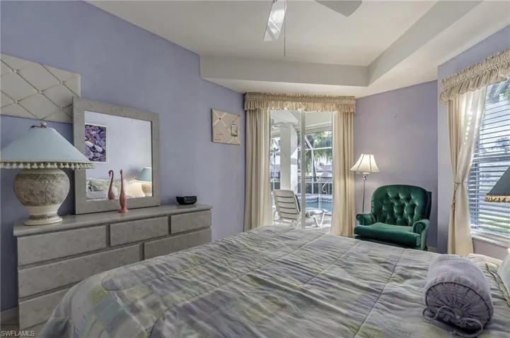 Bedroom featuring access to outside and a ceiling fan