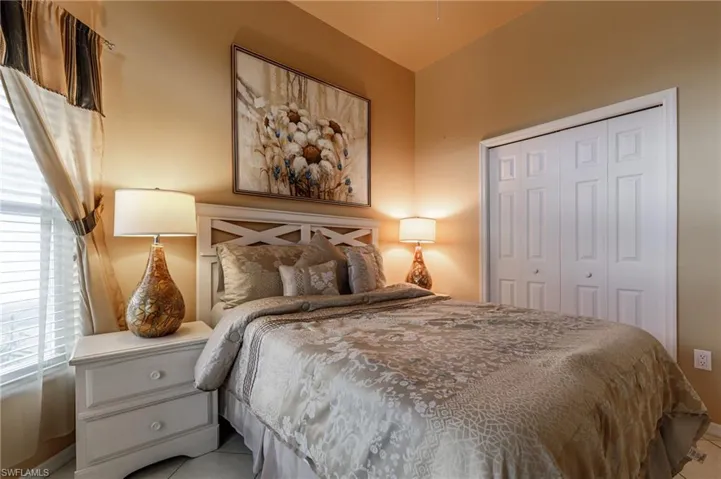Bedroom with a closet and tile patterned floors