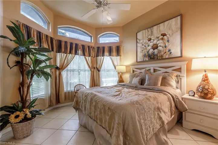 Tiled bedroom with ceiling fan