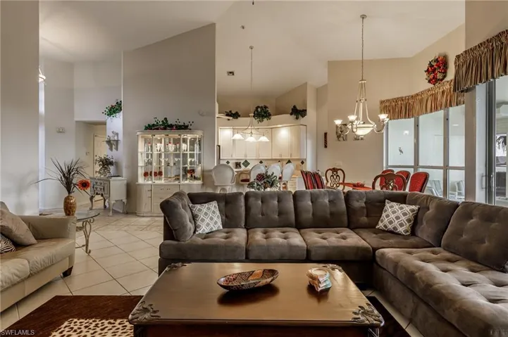 Kitchen with stainless steel fridge with ice dispenser, decorative backsplash, lofted ceiling, recessed lighting, and dishwasher