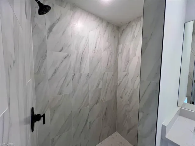 Primary bathroom walk in tiled shower.