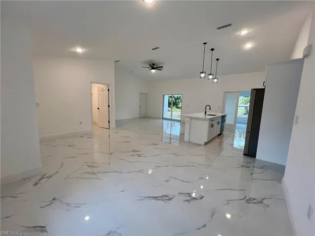Great room featuring high volume ceilings.