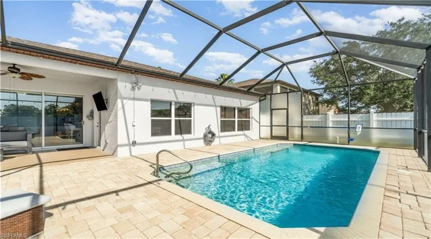 View of pool with a sunroom, a lanai, and a patio area