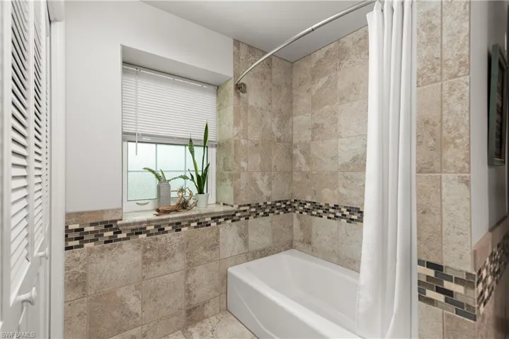 updated and clean guest bath with a tub/shower combination.