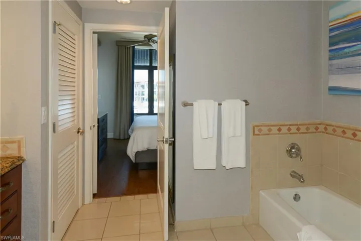 Ensuite bathroom featuring a shower/bath and vanity