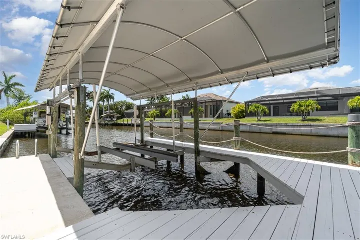 Wooden dock area with canopy and covered boat lift