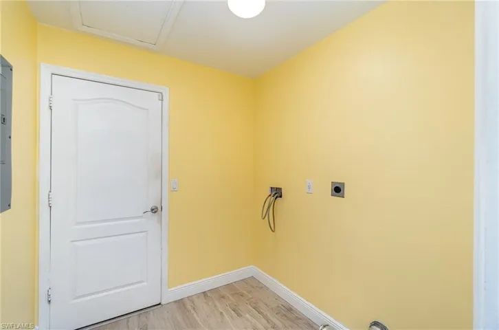 Laundry area featuring washer hookup, light hardwood / wood-style floors, and hookup for an electric dryer