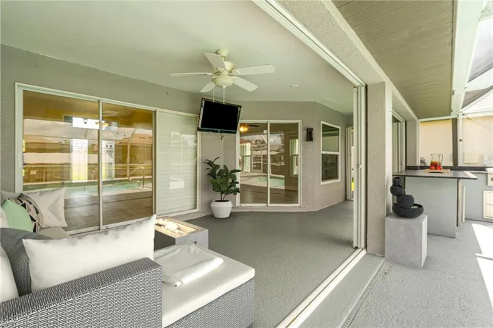 Virtually Staged view of lanai sitting area & outdoor bar/kitchen area
