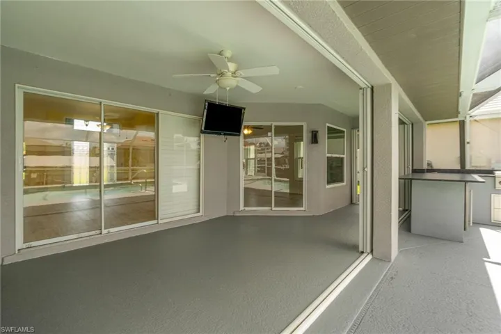 View of lanai sitting area & outdoor bar/kitchen area