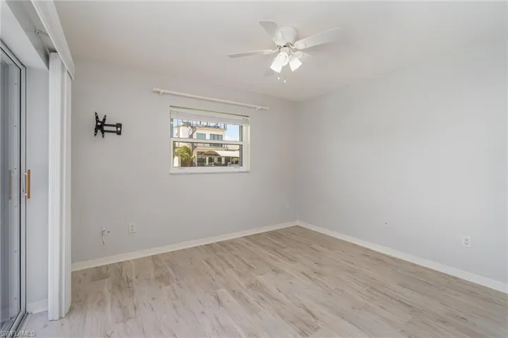 Unfurnished guest bedroom featuring ceiling fan and light hardwood / wood-style floors