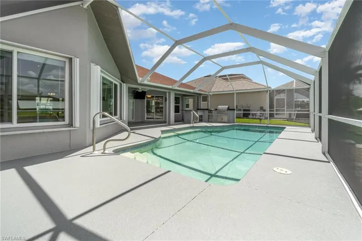 View of swimming pool & screened lanai area