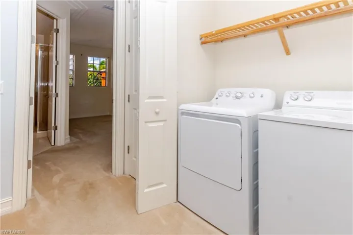 Laundry area featuring built-in shelving and dual appliance hookups