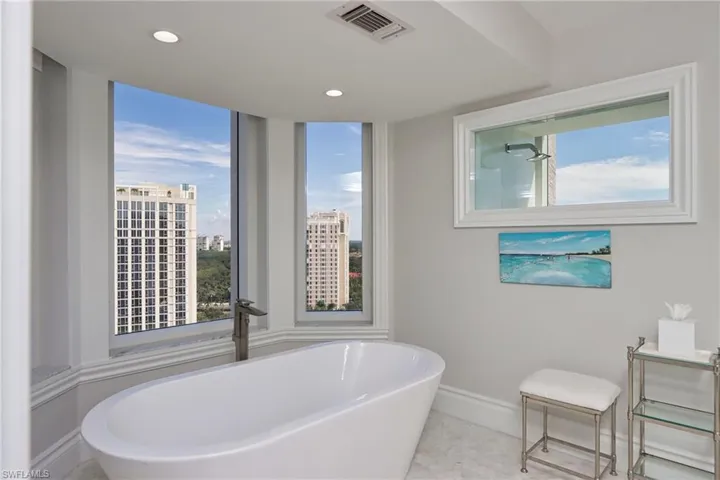 Bathroom with a bath and a wealth of natural light