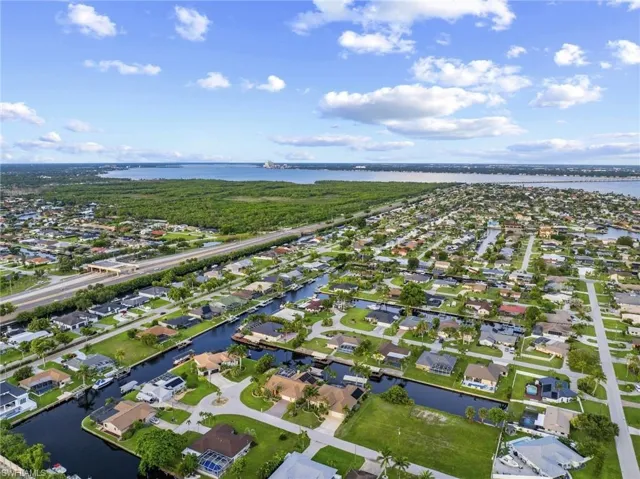 View of property location with a large body of water and nearby suburban area