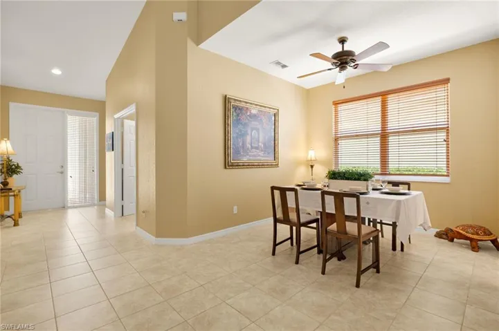 Dining room with light tile patterned flooring, a ceiling fan, baseboards, recessed lighting, and visible vents