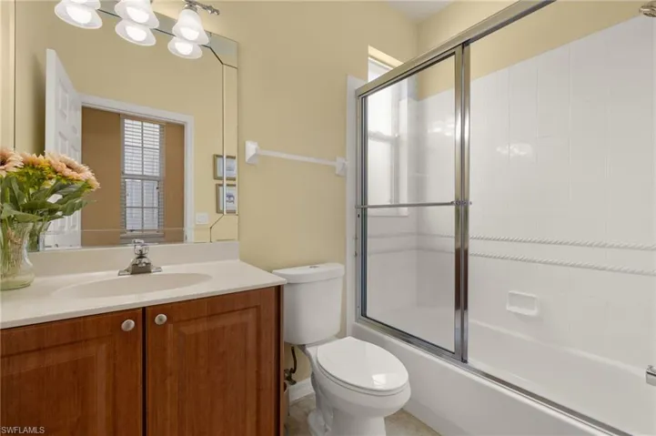 Full bath with toilet, combined bath / shower with glass door, and vanity
