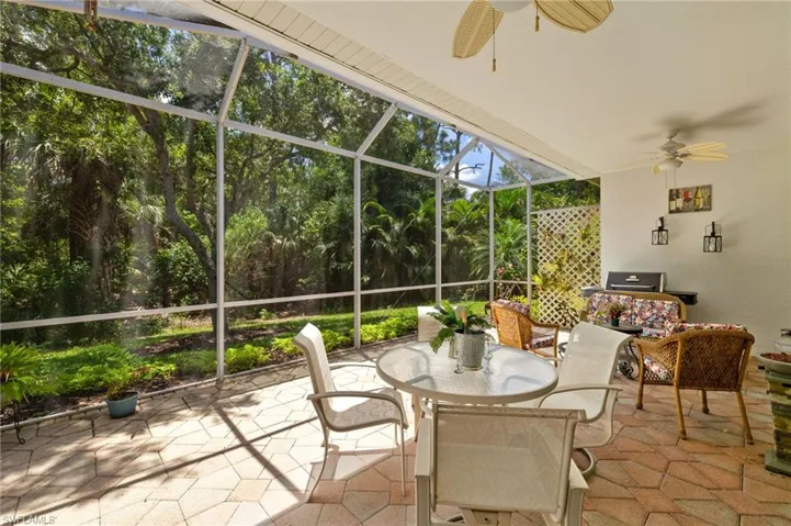 Sunroom featuring a ceiling fan and outdoor dining space