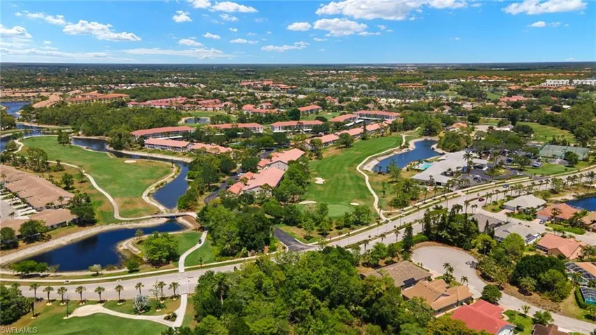 Drone / aerial view featuring a water view, view of golf course, and a residential view