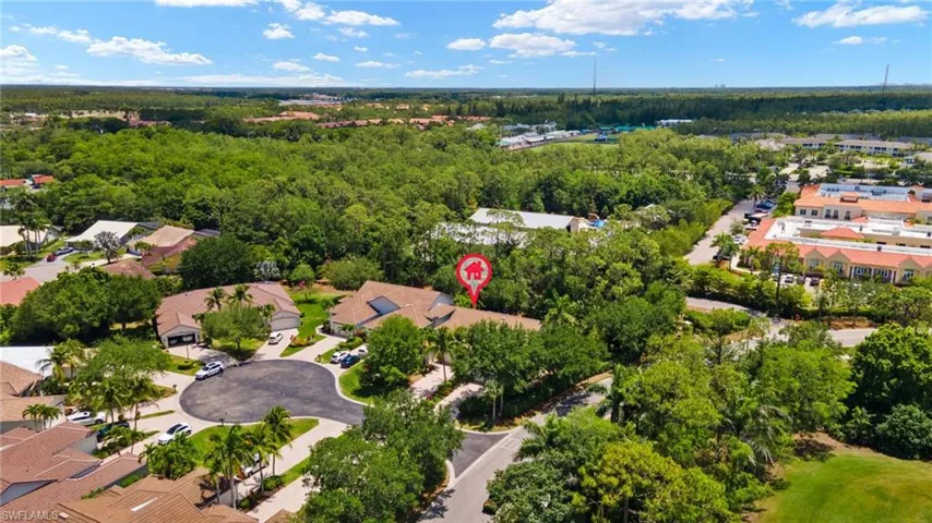 Birds eye view of property with a view of trees and a residential view