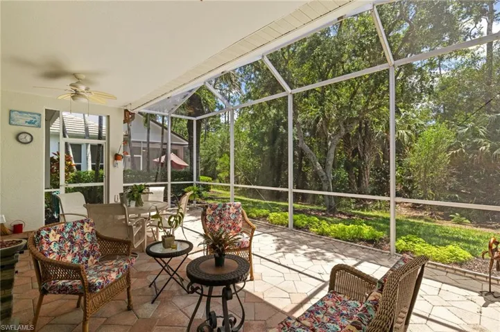 Sunroom / solarium featuring a ceiling fan and outdoor dining space