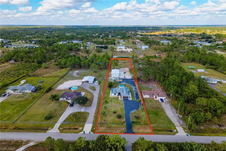 Aerial perspective of neighborhood property parcel outlined