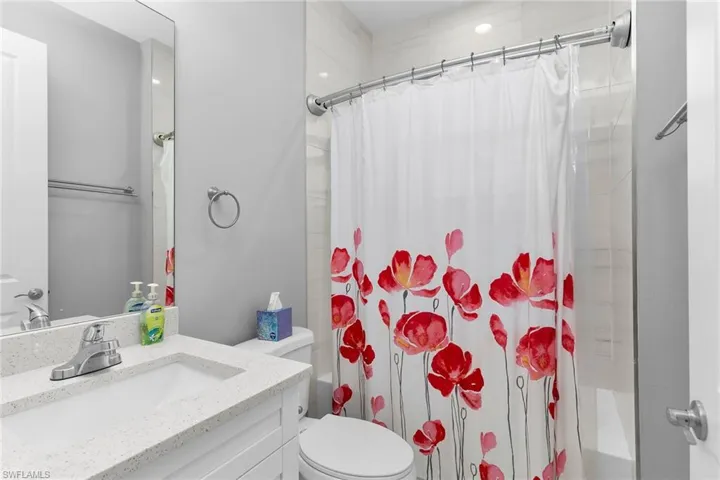 Bathroom featuring vanity and shower / tub combo with curtain