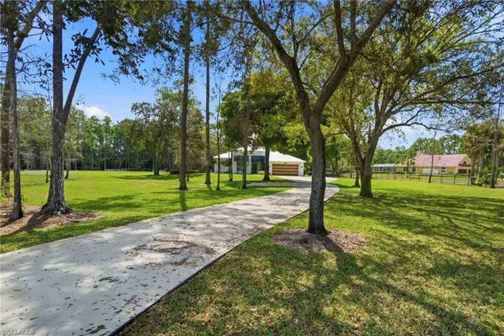 Long concrete driveway entrance to this 6 acre property