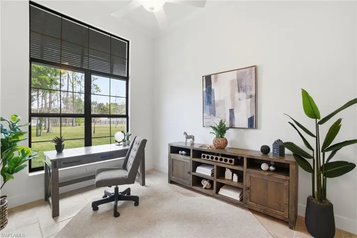 Office featuring ceiling fan, crown molding and large window