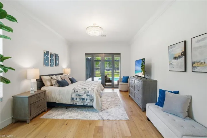 Bedroom featuring light wood flooring, access to outside, and crown molding