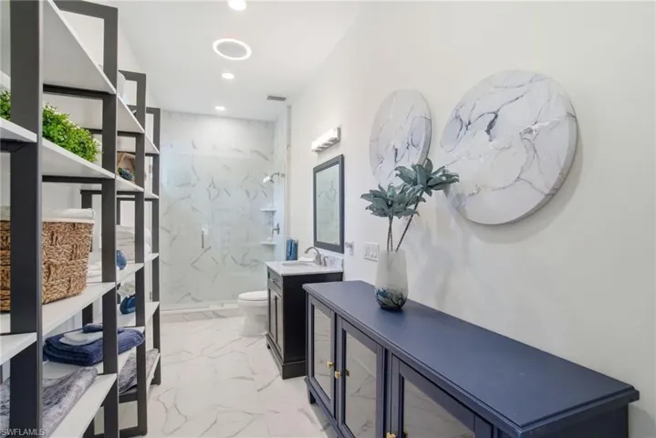 Guest Bathroom #2 with vanity, a marble finish shower, light marble finish flooring, and recessed lighting