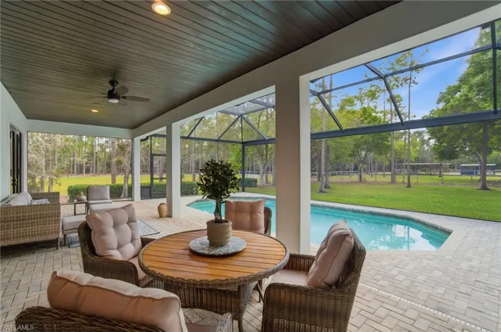 Covered area of screened lanai has space for outdoor dining and lounging