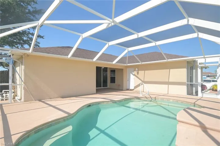 View of swimming pool with a patio and screen enclosure