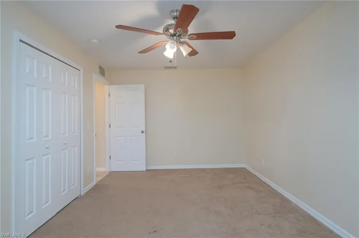 Unfurnished bedroom featuring carpet flooring, a closet, and ceiling fan