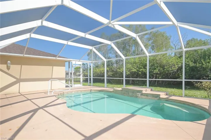 View of swimming pool, a lanai, and a patio area