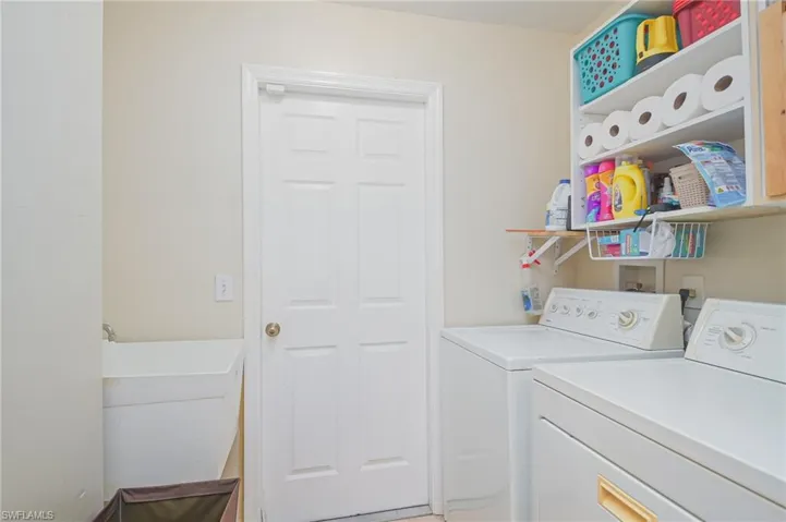 Clothes washing area featuring washer and dryer and washer hookup