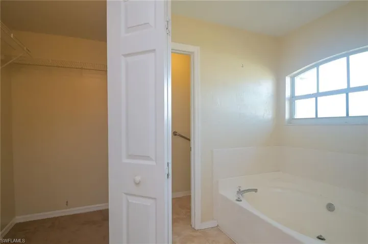 Bathroom with tile floors and a bathtub