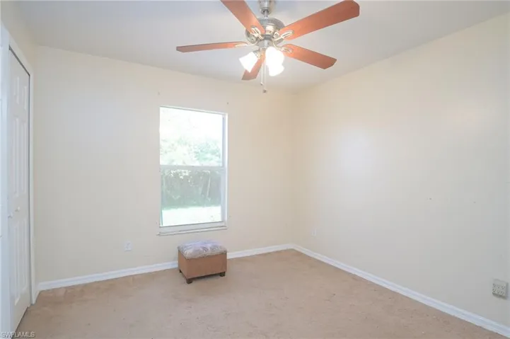 Spare room with carpet, ceiling fan, and plenty of natural light