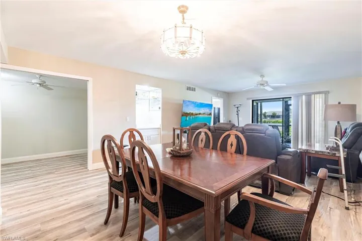 Dining area with ceiling fan and light wood-type flooring